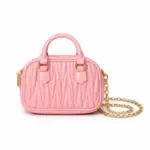 Women's baby pink textured mini dome handbag featuring top handle and gold chain strap