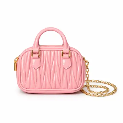 Women's baby pink textured mini dome handbag featuring top handle and gold chain strap