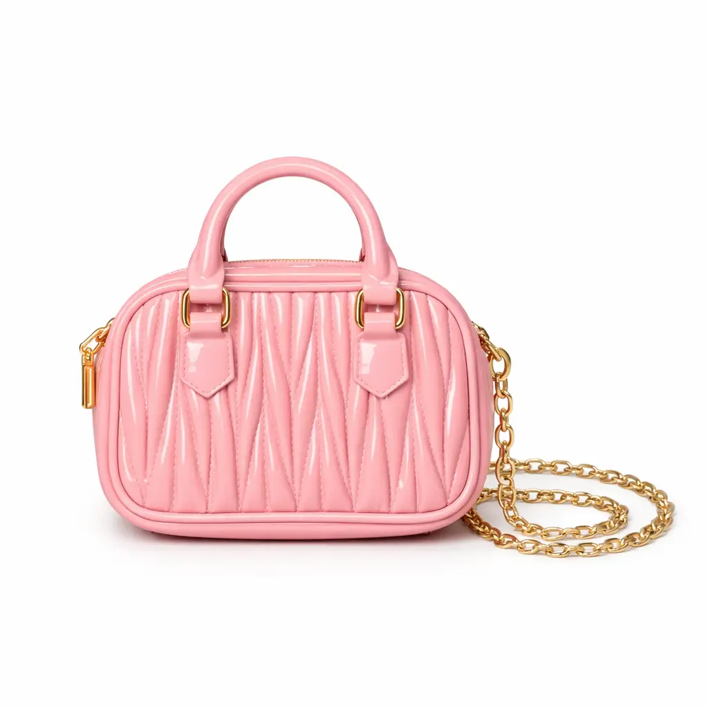 Women's baby pink textured mini dome handbag featuring top handle and gold chain strap