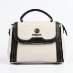 Front centered studio shot of the FOXJAZZ off-white handbag featuring a croco pattern flap, logo emblem, and black top handle.