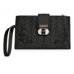 A chic, true black women's faux leather long wallet wristlet clutch with an all-black monochromatic design. Subtle, tonal black floral rose embroidery is symmetrical on the lower corners, divided by parallel vertical linear stitching. A central gunmetal twist-lock with a circular white insert and a black wristlet strap completes the accessory.