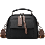 Classic jet black structured dome satchel handbag with brown studded zipper pull tags and wide shoulder strap.