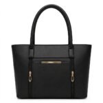 Front angle of a classic black leather tote bag with gold vertical zippers on a clean white backdrop.