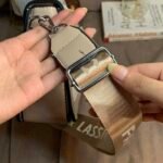 Close-up of the silver metal clasp and adjustment buckle on the CIEICI wide webbed guitar strap.