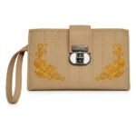 An oatmeal-beige women's faux leather long wallet wristlet. The light beige surface is detailed with parallel vertical linear stitching and symmetrical corner embroidery of intricate gold-colored floral rose patterns. A sophisticated, metallic mechanical twist-lock mechanism with a distinct circular white insert secures the wallet centrally. A beige wristlet strap is included.