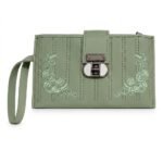A pale sage-green women's faux leather long wallet or wristlet clutch. It features distinctive vertical stitching columns and symmetrical corner floral patterns of intricate light-green thread roses and tendrils. The central locking mechanism is a distinctive, dark metallic mechanical turn-lock with a unique white porcelain-like insert. A green wristlet strap is attached to the left.